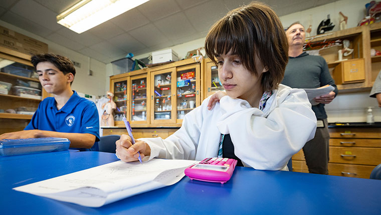 A student at Greenwood Laboratory School completes a math assignment using a calculator.